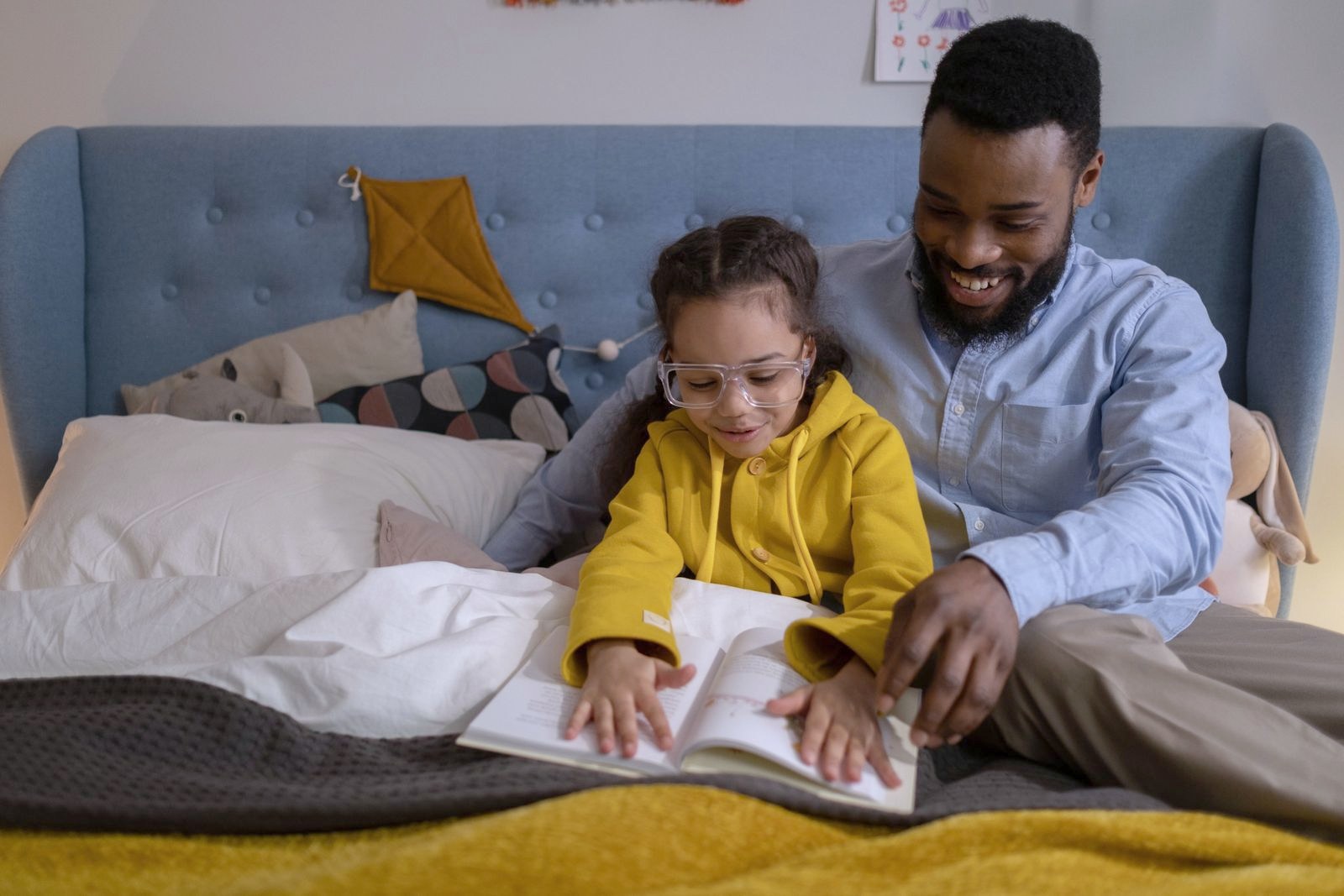 A father and daughter reading a book together