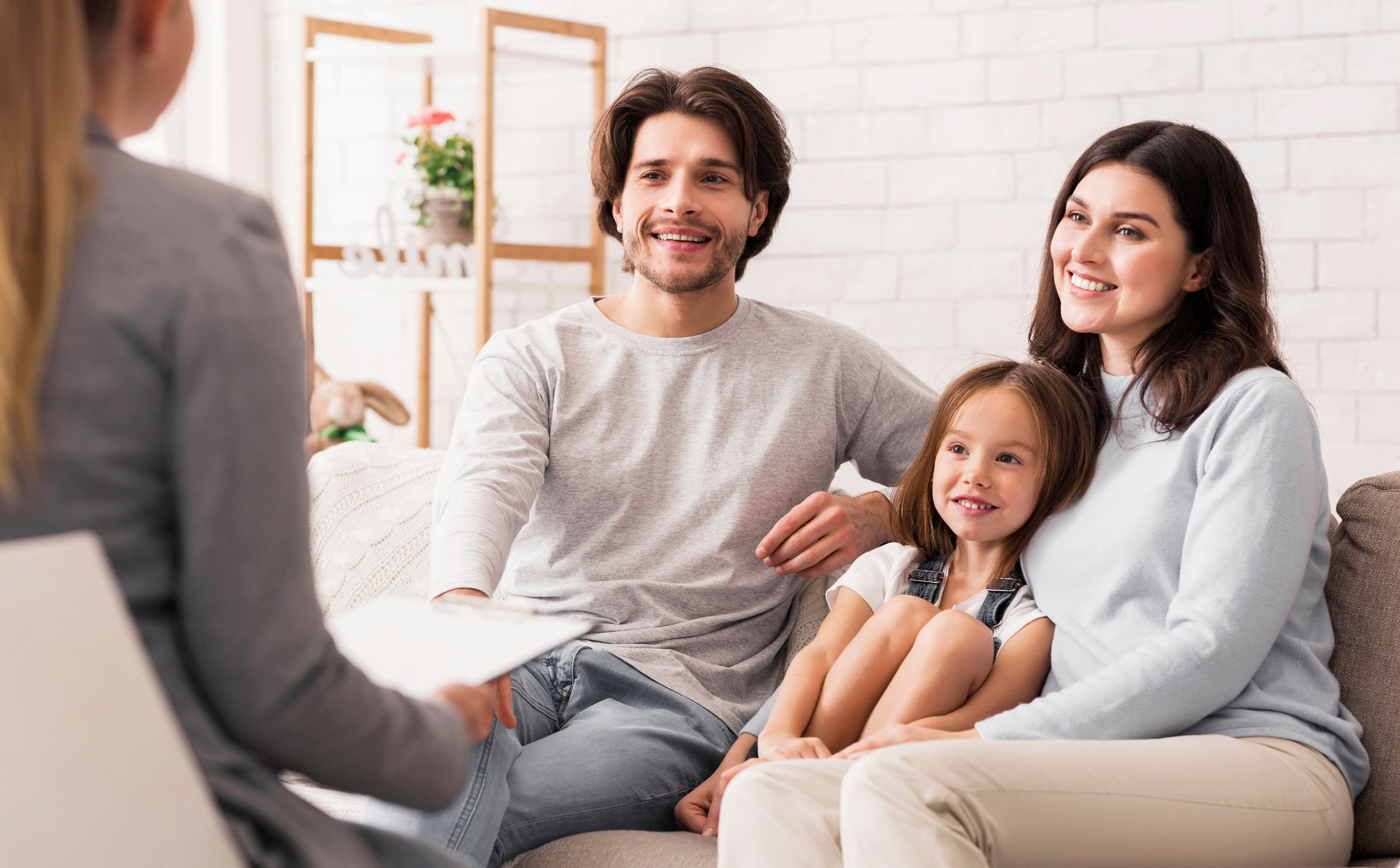 Parents and their young daughter meeting with a psychologist